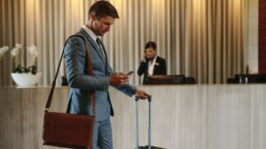 Businessman checking phone in hotel lobby